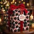 Luxury Black Santa wrapping paper with red velvet ribbon on a Christmas gift by Wrapped Studios.