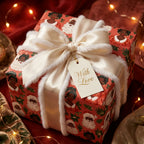 Black Santa Christmas wrapping paper with ivory fur-trimmed ribbon, by Wrapped Studios.