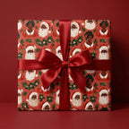 Black Santa and Mrs. Claus Christmas wrapping paper with a red satin bow by Wrapped Studios.