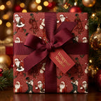 Black Santa luxury Christmas gift wrap with a burgundy bow and tag, by Wrapped Studios.