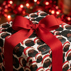 Black Santa Christmas wrapping paper with a red ribbon by Wrapped Studios.