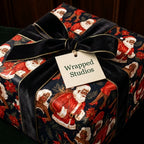 Vintage Black Santa Christmas wrapping paper by Wrapped Studios on a gift box with a luxury black velvet bow.