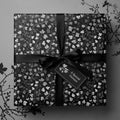 Elegant floral wrapping paper in monochrome with black ribbon and a "Special Gesture" tag.