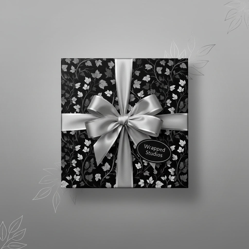 Elegant floral wrapping paper in black and silver with satin bow, luxury gift wrap.