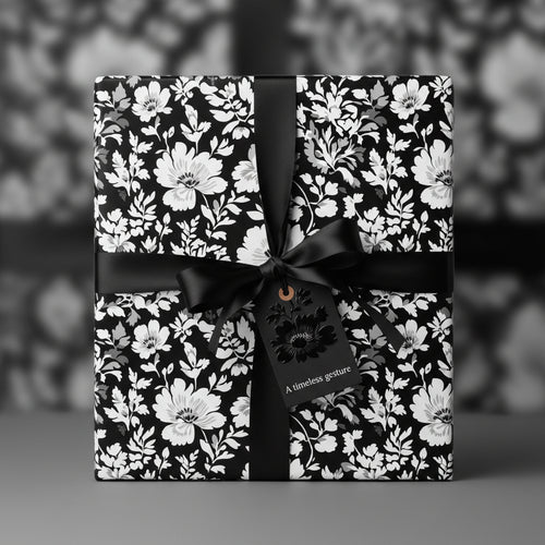 Elegant floral wrapping paper in black and white, tied with a black satin ribbon and gift tag.