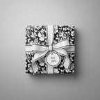 Black and white floral wrapping paper with elegant ribbon, "For you" tag.