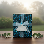 Stylish gift wrapped in blue raindrop pattern wrapping paper with light blue ribbon.