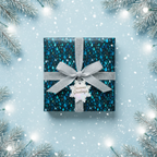 Elegant Christmas gift wrap with a blue rain drop pattern, silver ribbon, and "Seasons Greetings" tag.