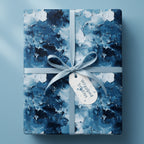 Abstract blue and white luxury gift wrap with ribbon and tag on a square gift box.