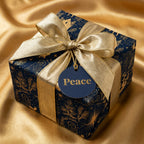 Navy and gold luxury Christmas wrapping paper with nativity scene and gold bow by Wrapped Studios.