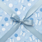 Light blue birthday wrapping paper with a satin ribbon and balloon and gift pattern.