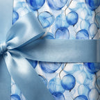 Wrapped Studios baby shower wrapping paper. Light blue watercolor balloon pattern with satin ribbon.