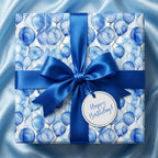 Blue balloon birthday wrapping paper with matching ribbon on gift box from Wrapped Studios.