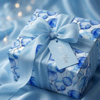 Wrapped gift with blue balloon print wrapping paper and ribbon for baby shower.