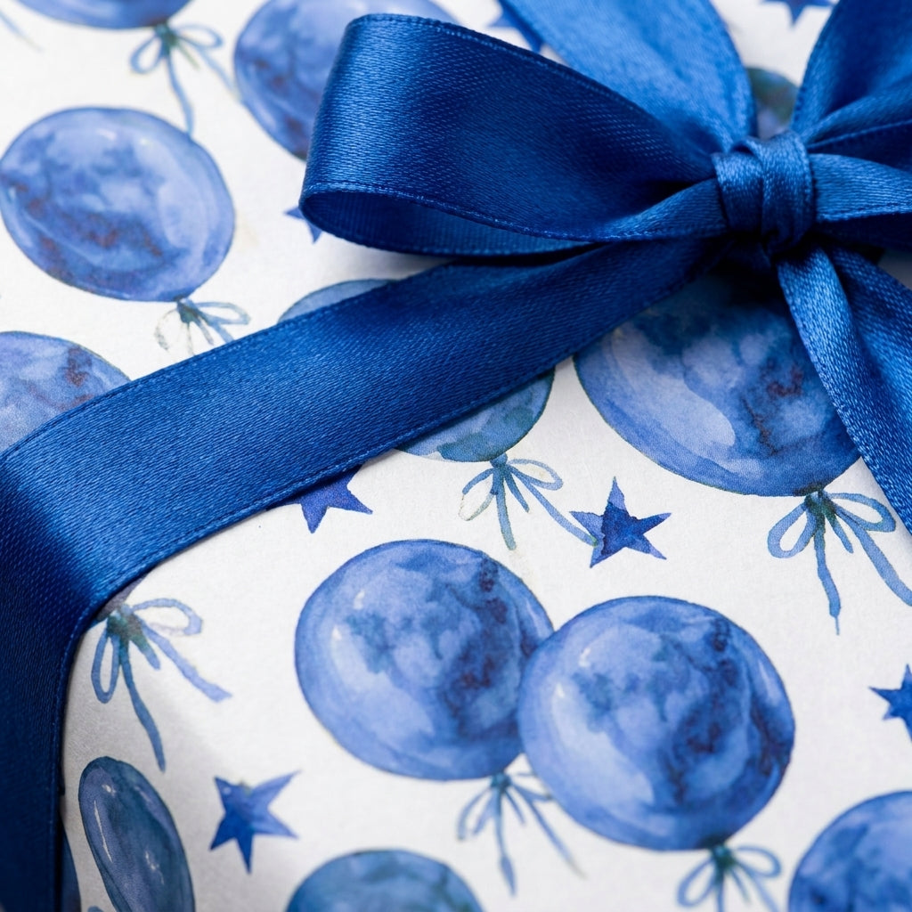 Blue watercolor balloon birthday wrapping paper with a matching satin bow by Wrapped Studios.