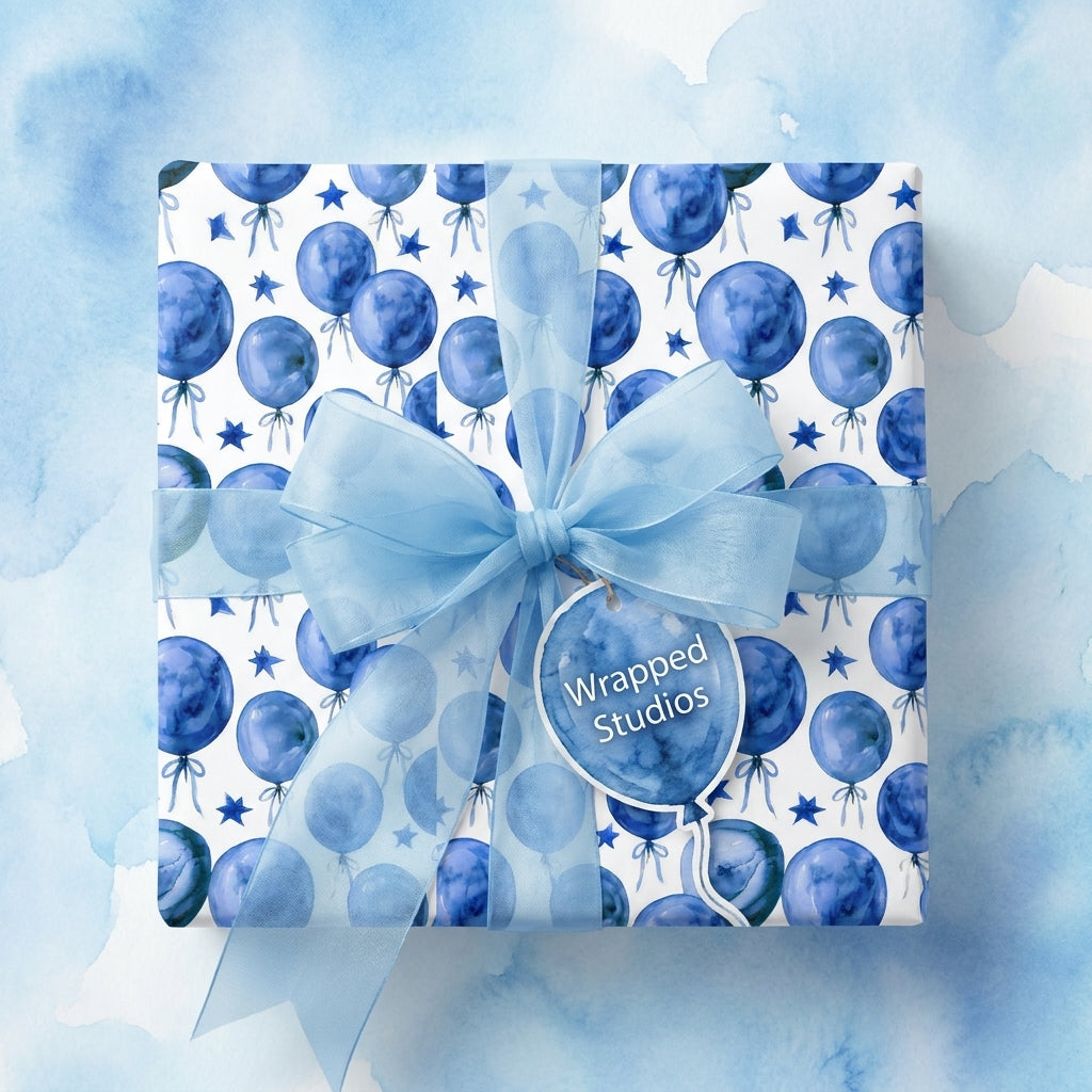 Blue watercolor balloon birthday wrapping paper with a sheer bow and gift tag by Wrapped Studios.