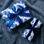 Blue watercolor balloon birthday wrapping paper with luxury bows by Wrapped Studios.