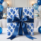 Watercolor blue balloon birthday wrapping paper with a luxury navy bow by Wrapped Studios.