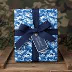 Blue camo wrapping paper with navy ribbon on wood crate.