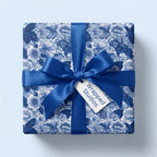 Luxury blue and white floral wrapping paper with a matching satin ribbon and bow by Wrapped Studios.