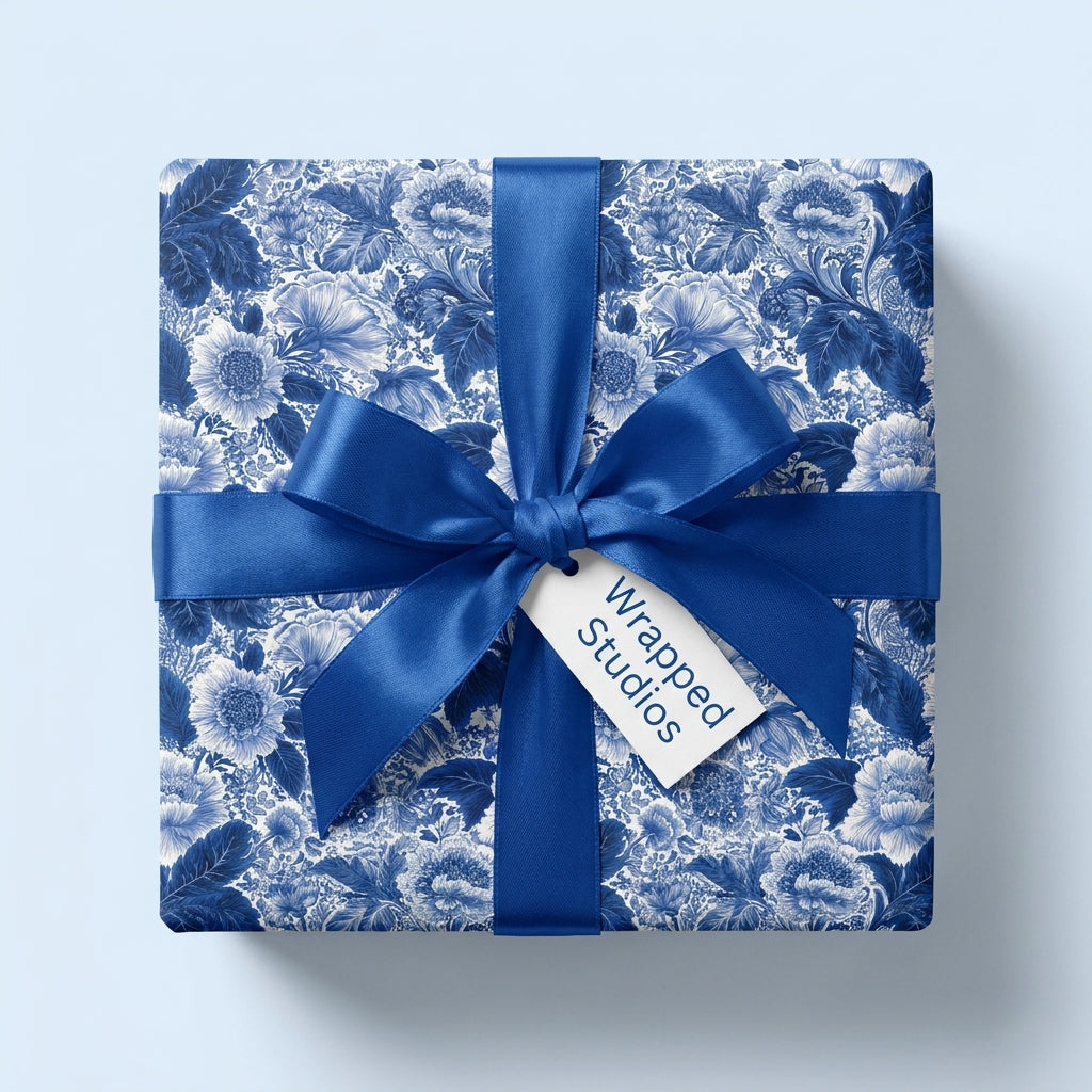 Luxury blue and white floral wrapping paper with a matching satin ribbon and bow by Wrapped Studios.
