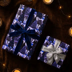 Luxury Christmas wrapping paper with a blue winter forest print and elegant velvet bow by Wrapped Studios.