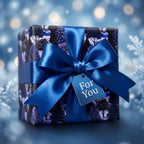 Blue winter forest Christmas wrapping paper with a luxury satin bow and gift tag by Wrapped Studios.
