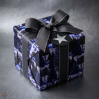 Elegant winter forest Christmas wrapping paper in dark blue with a black ribbon bow by Wrapped Studios.