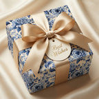 Elegant gift wrapped in blue floral wrapping paper with a gold ribbon and "Best Wishes" tag.