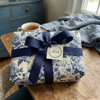 Elegant floral wrapping paper with navy ribbon and "Mom" tag. Great Mother's Day gift wrap!