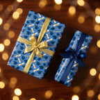 Blue graduation wrapping paper with congrats print and gold ribbon by Wrapped Studios.