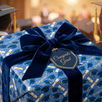 Luxury graduation wrapping paper in blue with a navy velvet bow and congrats tag by Wrapped Studios.