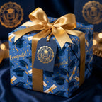 Navy and gold graduation wrapping paper with congrats print and a gold ribbon by Wrapped Studios.