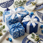 Hanukkah wrapping paper with blue Star of David patterns and white ribbons by Wrapped Studios.