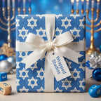 Blue Hanukkah gift wrap with white Star of David pattern and elegant cream bow by Wrapped Studios.
