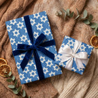 Hanukkah wrapping paper with Star of David pattern on gifts with velvet ribbons by Wrapped Studios.