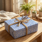 Modern blue wavy pattern wrapping paper tied with jute twine and lavender sprigs for a natural, rustic gift.