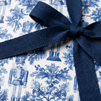 Luxury blue and white nutcracker Christmas gift wrap with a navy ribbon by Wrapped Studios.