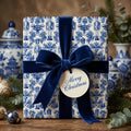 Luxury blue and white nutcracker Christmas wrapping paper with a navy velvet ribbon by Wrapped Studios.