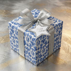 Blue nutcracker holiday wrapping paper with a silver ribbon on a Christmas gift box, by Wrapped Studios.
