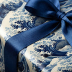 Luxury gift wrap with blue and white wave pattern and a shiny navy satin bow.