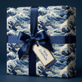 Sophisticated navy wave wrapping paper with a satin ribbon and "With Gratitude" tag for elegant gift-giving.