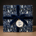 Dark blue owl gift wrapping paper with velvet ribbon and "For You" tag.