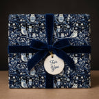 Dark blue owl gift wrapping paper with velvet ribbon and "For You" tag.