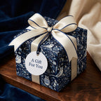 Elegant gift box in blue owl floral wrapping paper with cream ribbon, tag reads "A Gift For You". Wrapped Studios.