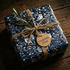 Gift wrapped in blue floral wrapping paper with owls, twine bow, and "Congrats, Grad" tag.