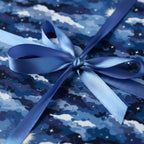 Elegant blue gift wrap with star and cloud pattern, finished with a satin ribbon bow.