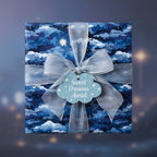Blue night sky wrapping paper with clouds and stars, tied with a sheer silver ribbon and “Sweet Dreams Await” gift tag.