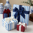Luxury blue and white striped wrapping paper with elegant bows on gift boxes by Wrapped Studios.