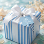 Blue and white striped wrapping paper with a white satin bow, coastal beach gift wrap by Wrapped Studios.